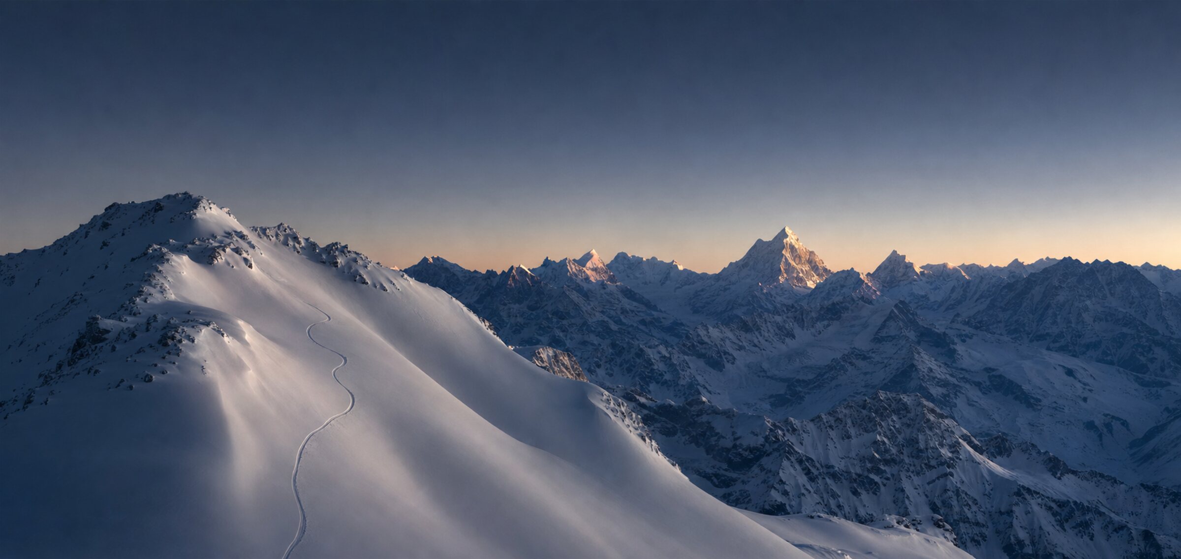 A single ski track on an untouched alpine ridge at first light